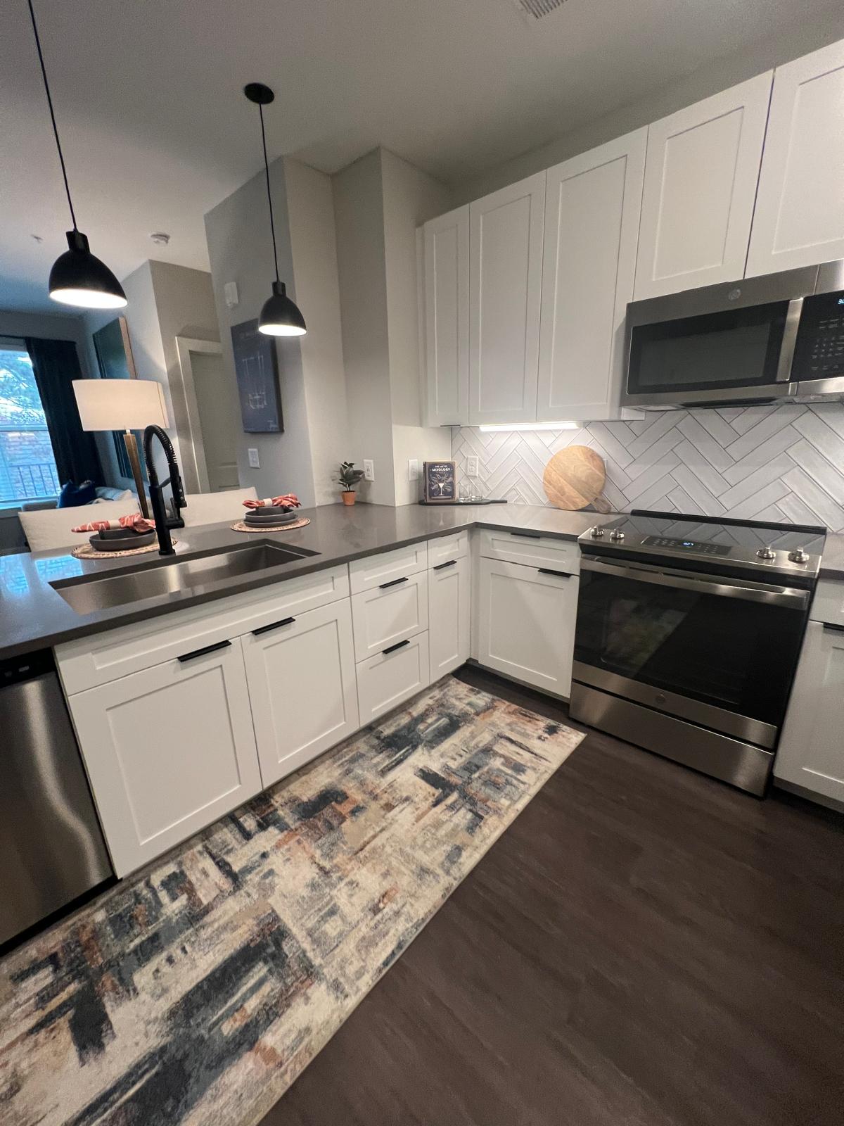 Furnished model apartment kitchen cleaned and staged for leasing tours