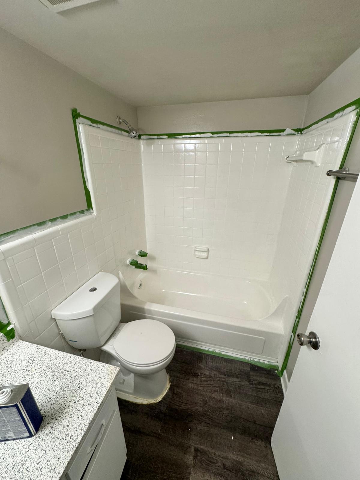 Bathtub and tile resurfacing in progress for multifamily apartment unit