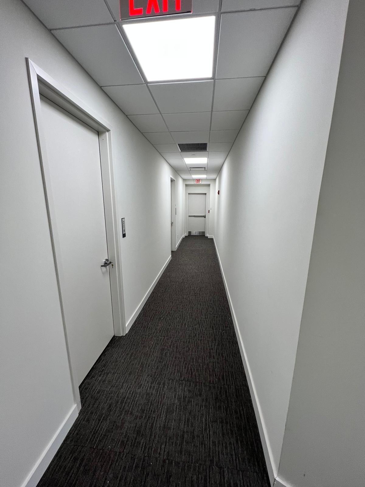 Completed interior corridor repaint with finished walls, doors and trim