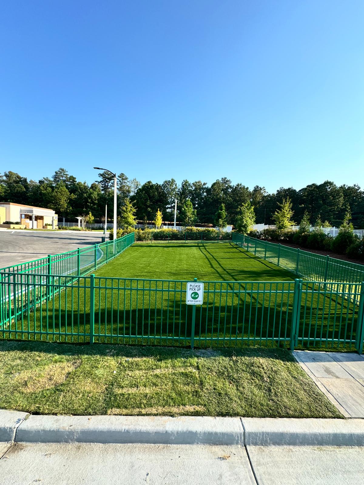 Multifamily dog park before and after artificial turf installation — after
